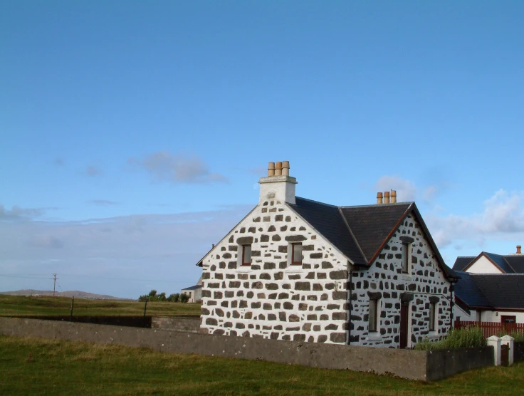 a house made out of white rocks in front of the sky