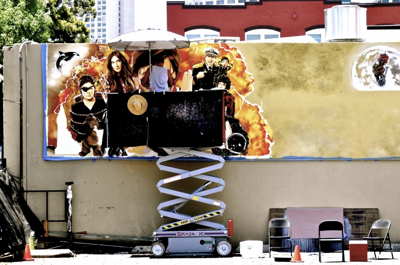 a painting of two woman on a wall next to a car