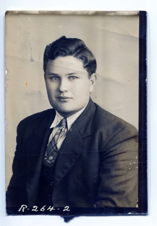 a man in a suit posing for a picture