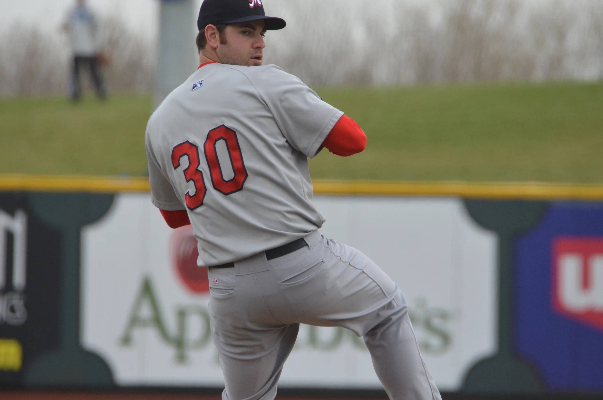 baseball player throwing baseball in field during game