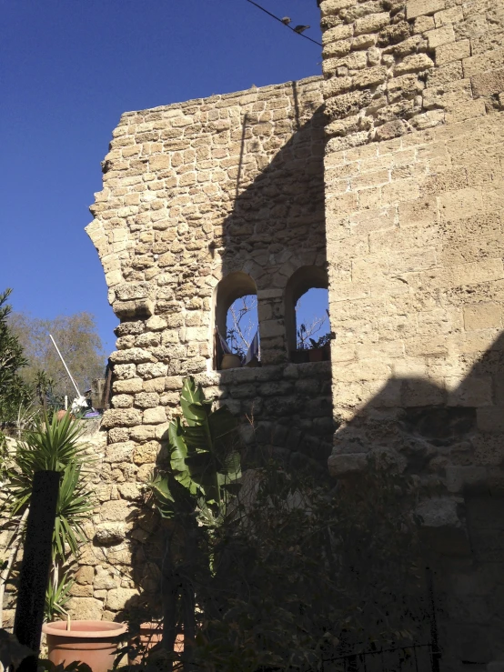 a stone wall of a building with an open window