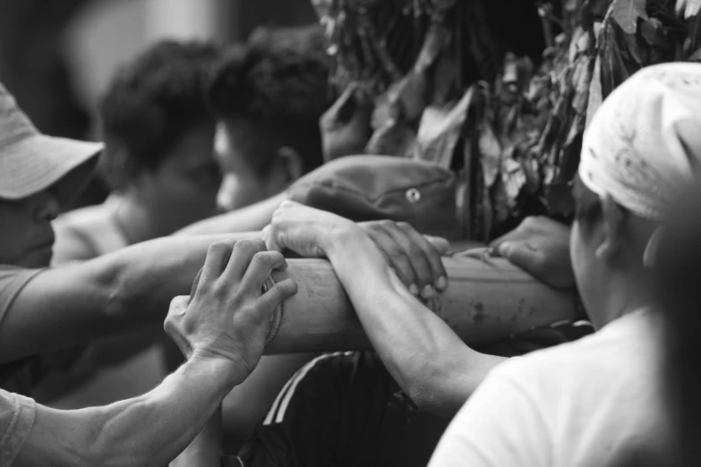 a group of people sitting next to each other with hands