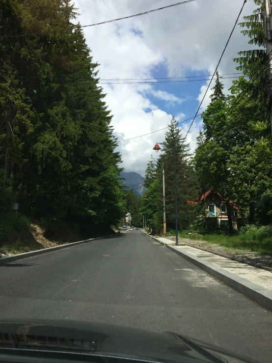 street view from inside a car as cars drive along