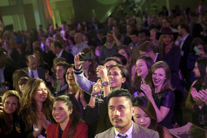 several people are standing near some people who are taking pictures