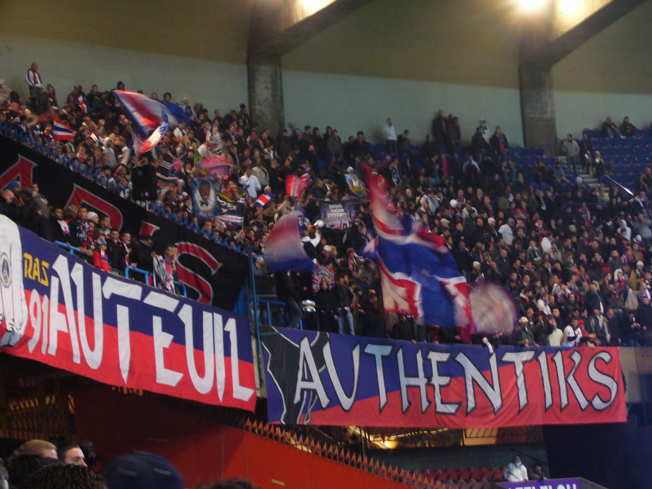 a crowded stadium with fans and banners