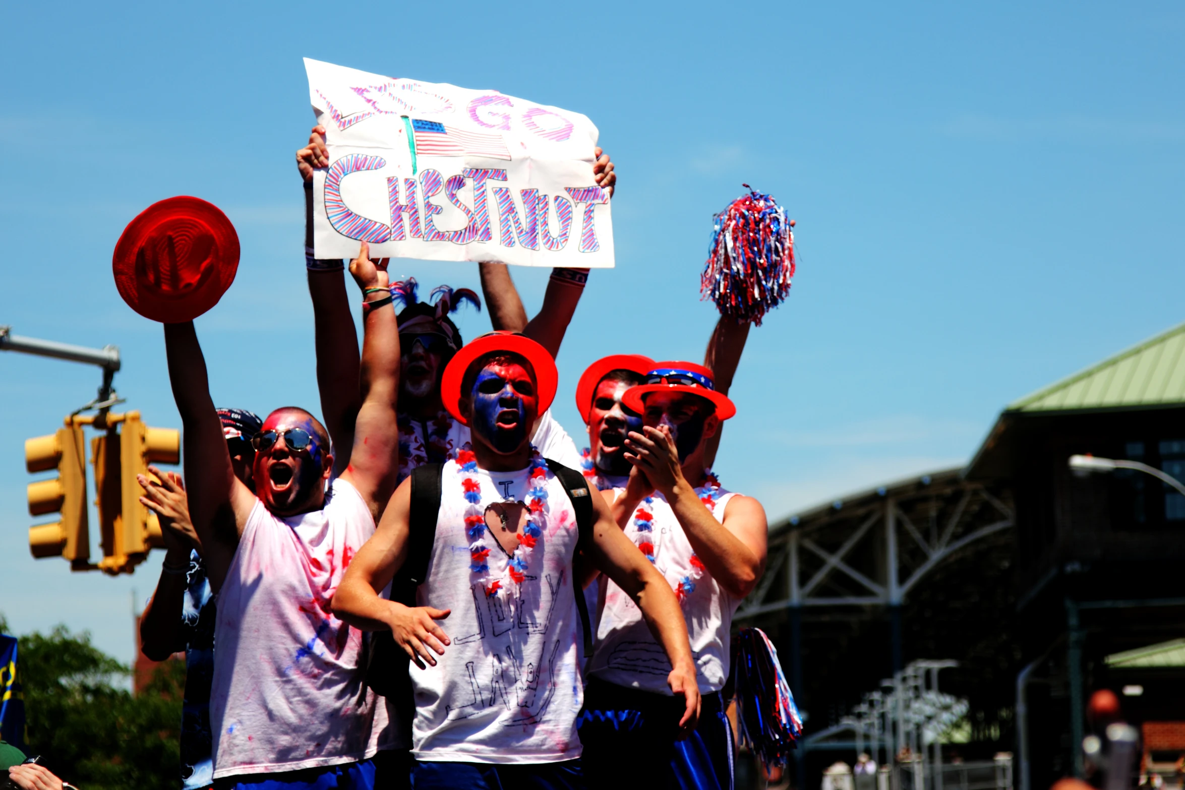 the people are all wearing their red, white, and blue hats