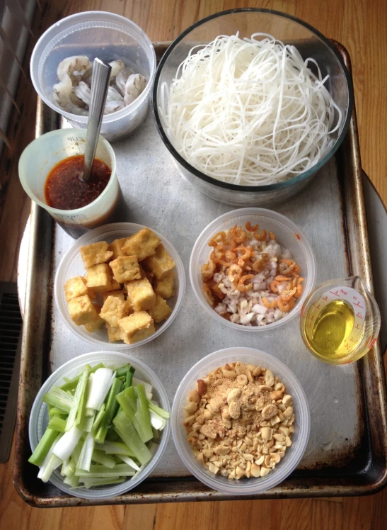 several bowls with different ingredients are on a tray