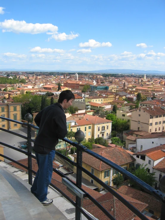 a person is standing on the balcony of a building