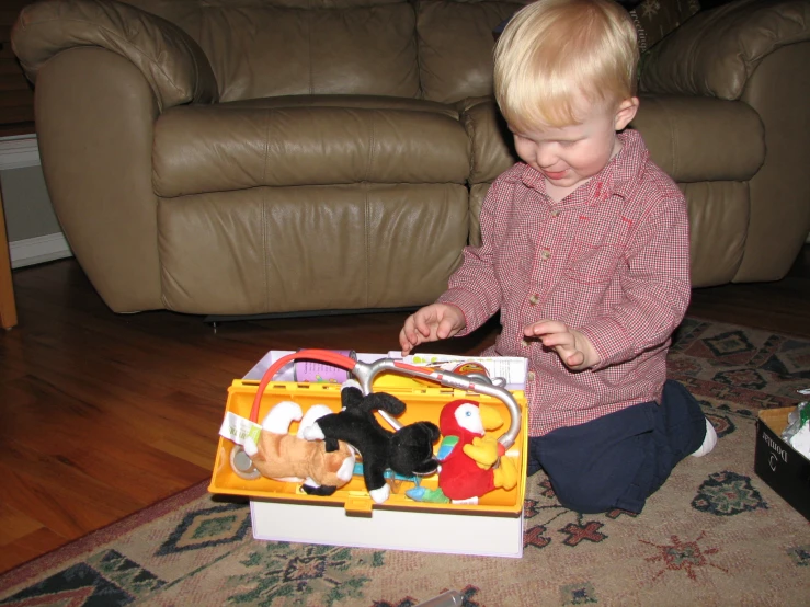 a young child is playing with toys on the floor