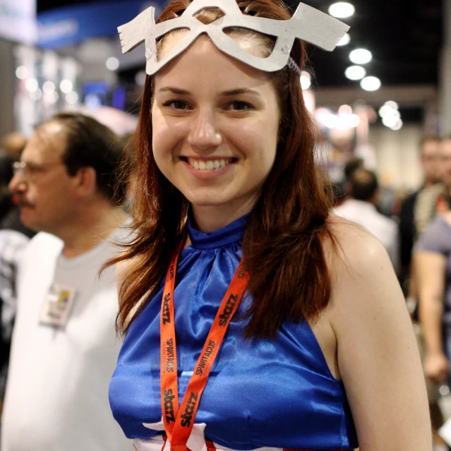 a young woman with a blue dress has a ribbon around her waist and a pair of goggles hanging on her head