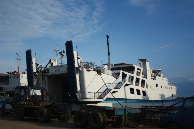 a truck carrying a ship up to the dock