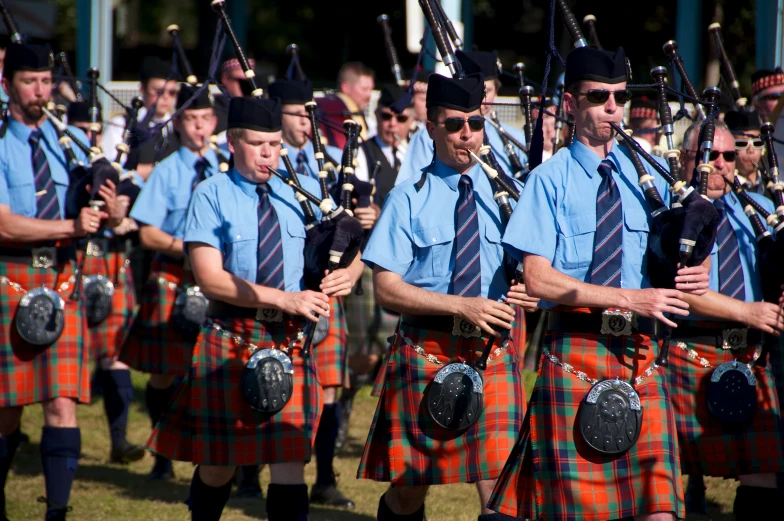 a group of men in kilts dancing together