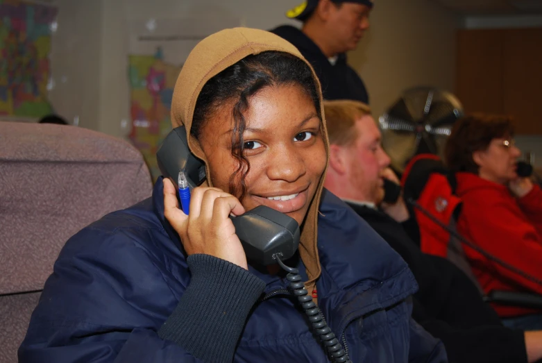 the woman smiles and talks on a phone