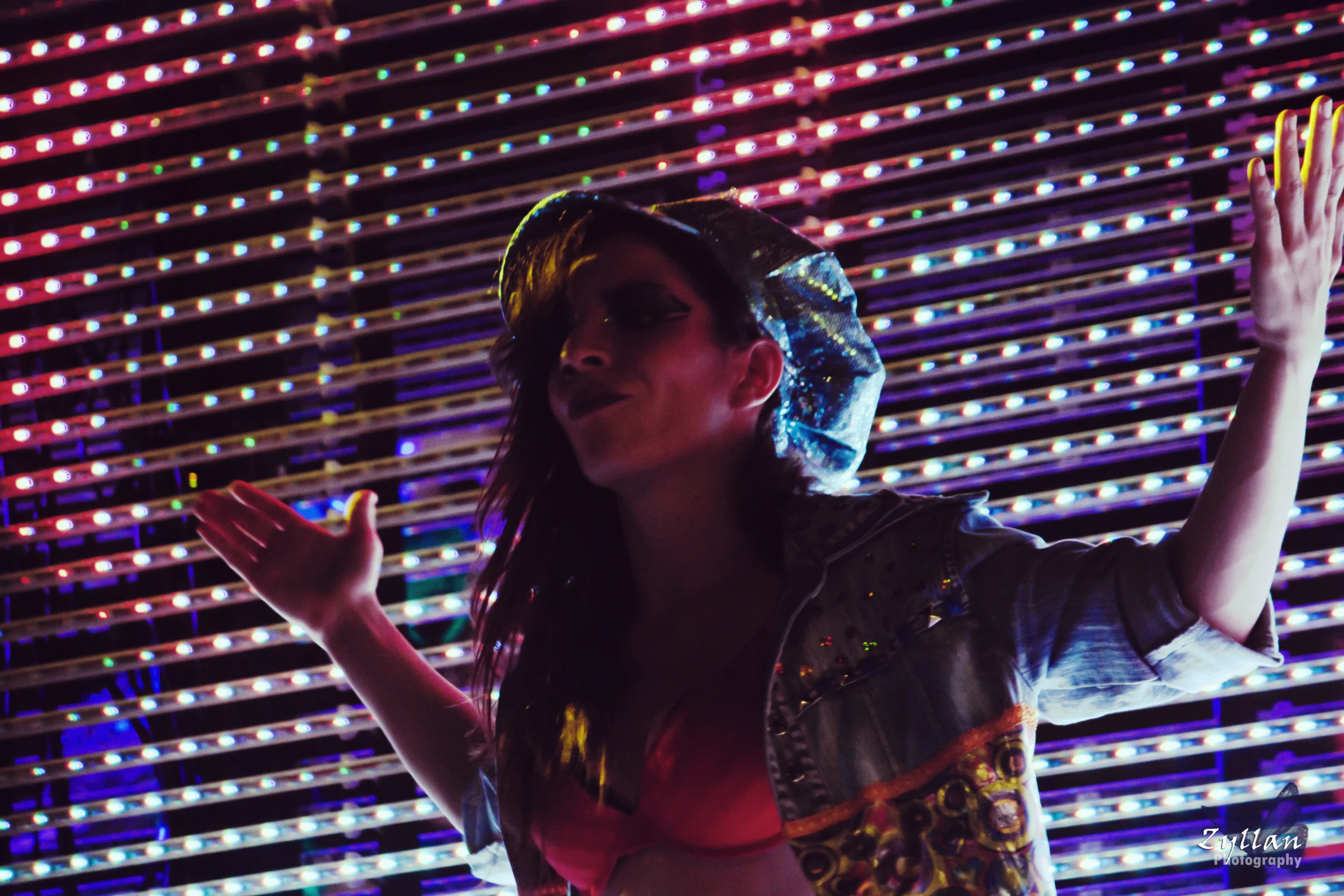 a woman wearing a colorful hat and standing up