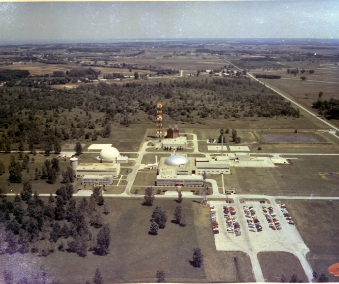 an aerial po of a factory and surrounding trees