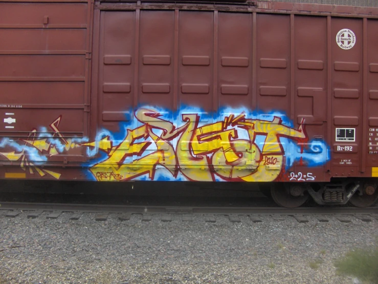 train car with grafitti on it next to an empty lot
