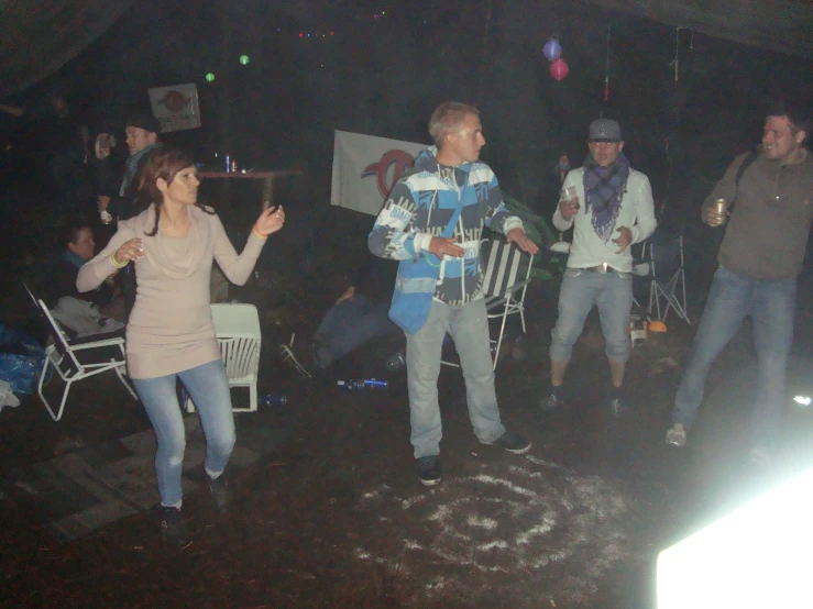 a group of people dancing at a party