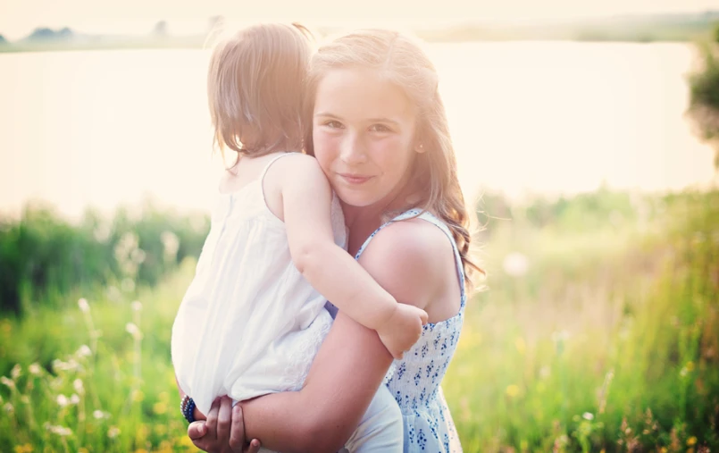 a  hugging her mom in the park