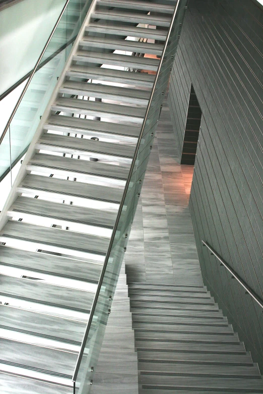 metal steps with glass railing against black building