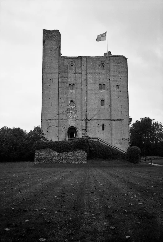 a large white brick tower sitting on top of a field