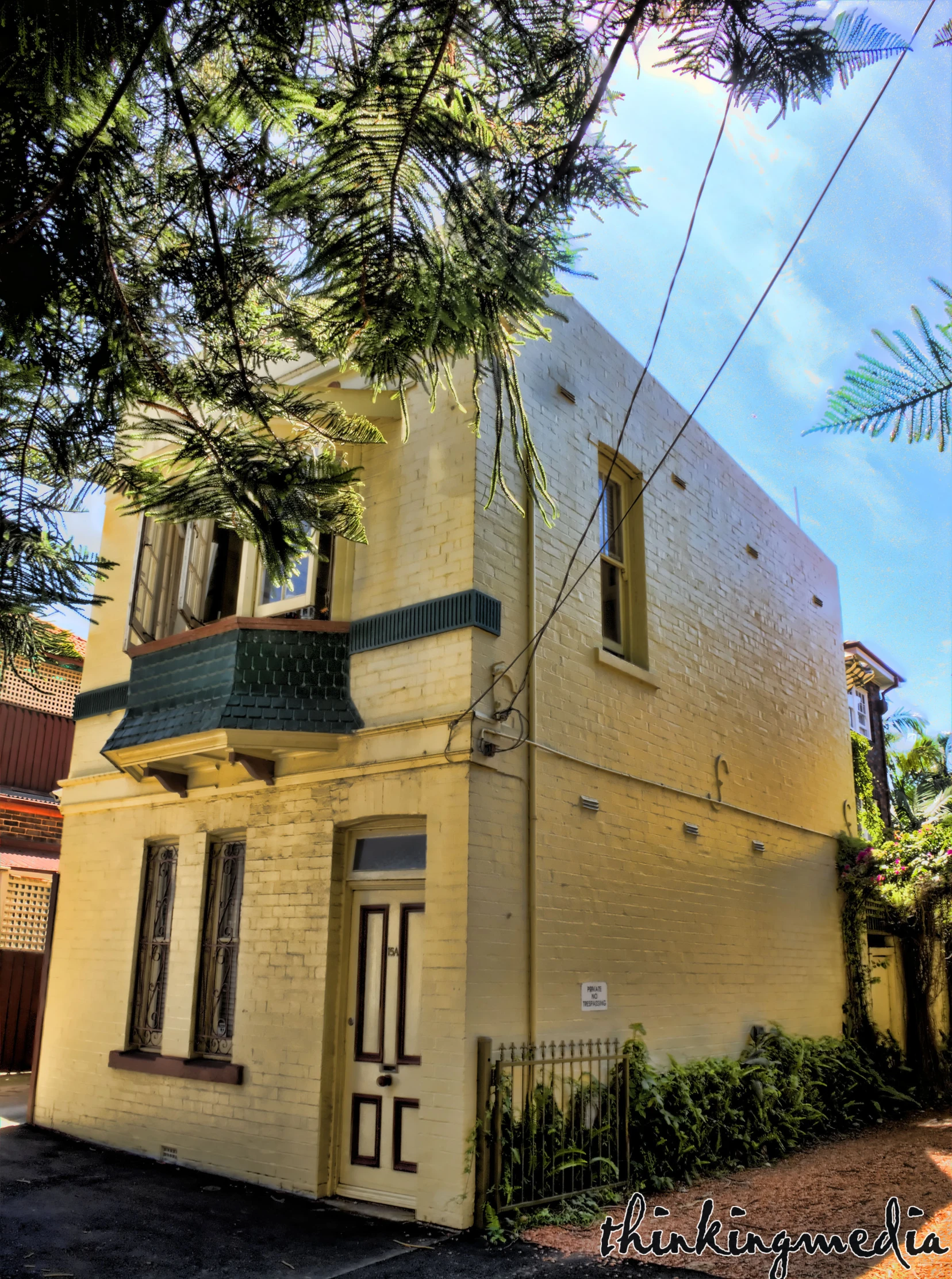 a building is shown with plants on the sidewalk