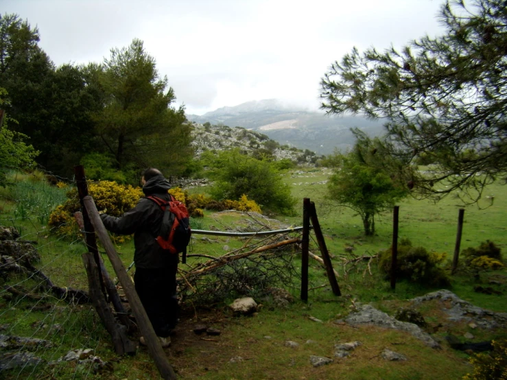 a person is walking up a path toward a fence