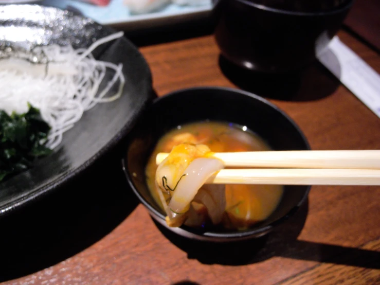 a small bowl with chopsticks sticking out of it