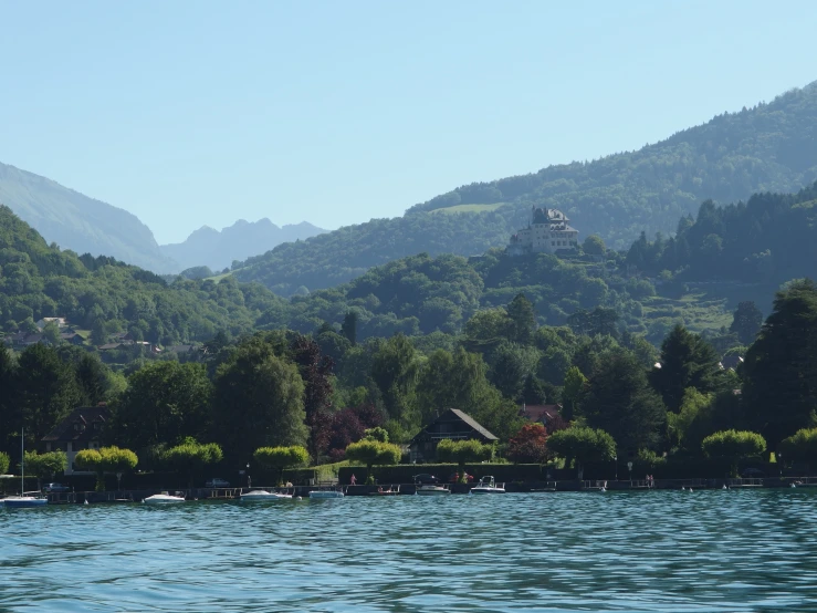 mountains and the sea in the distance with boats in them