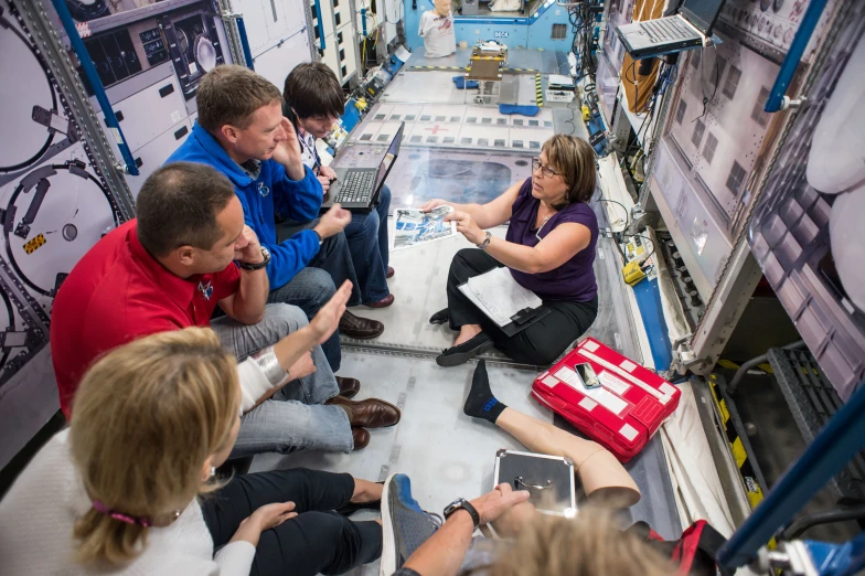 a group of people sit in an automated room