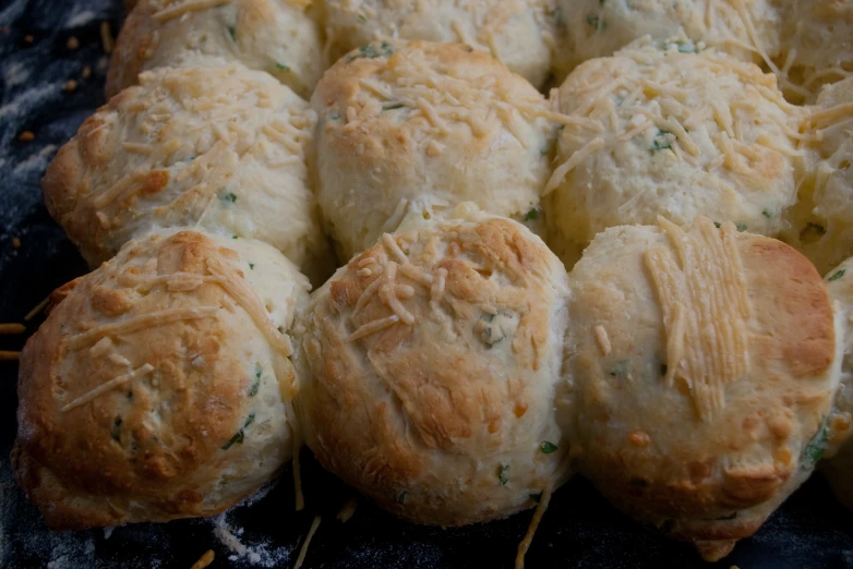 a tray filled with cheese biscuits sitting on top of a table