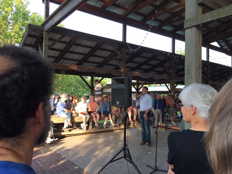 the speaker is giving a talk to a crowd