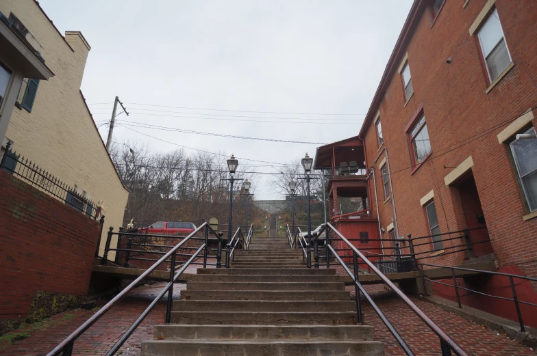 several stairs going up to two buildings and a fire hydrant