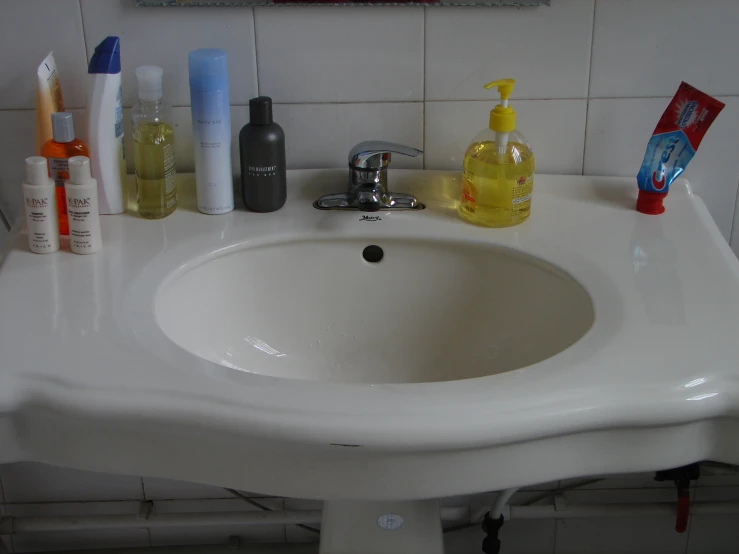 a close up of a sink with all sorts of soap