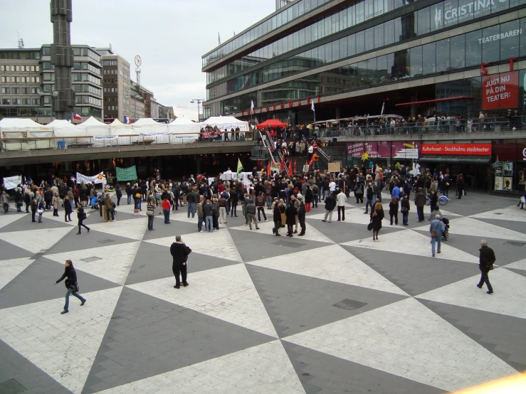 a group of people stand in the middle of a floor