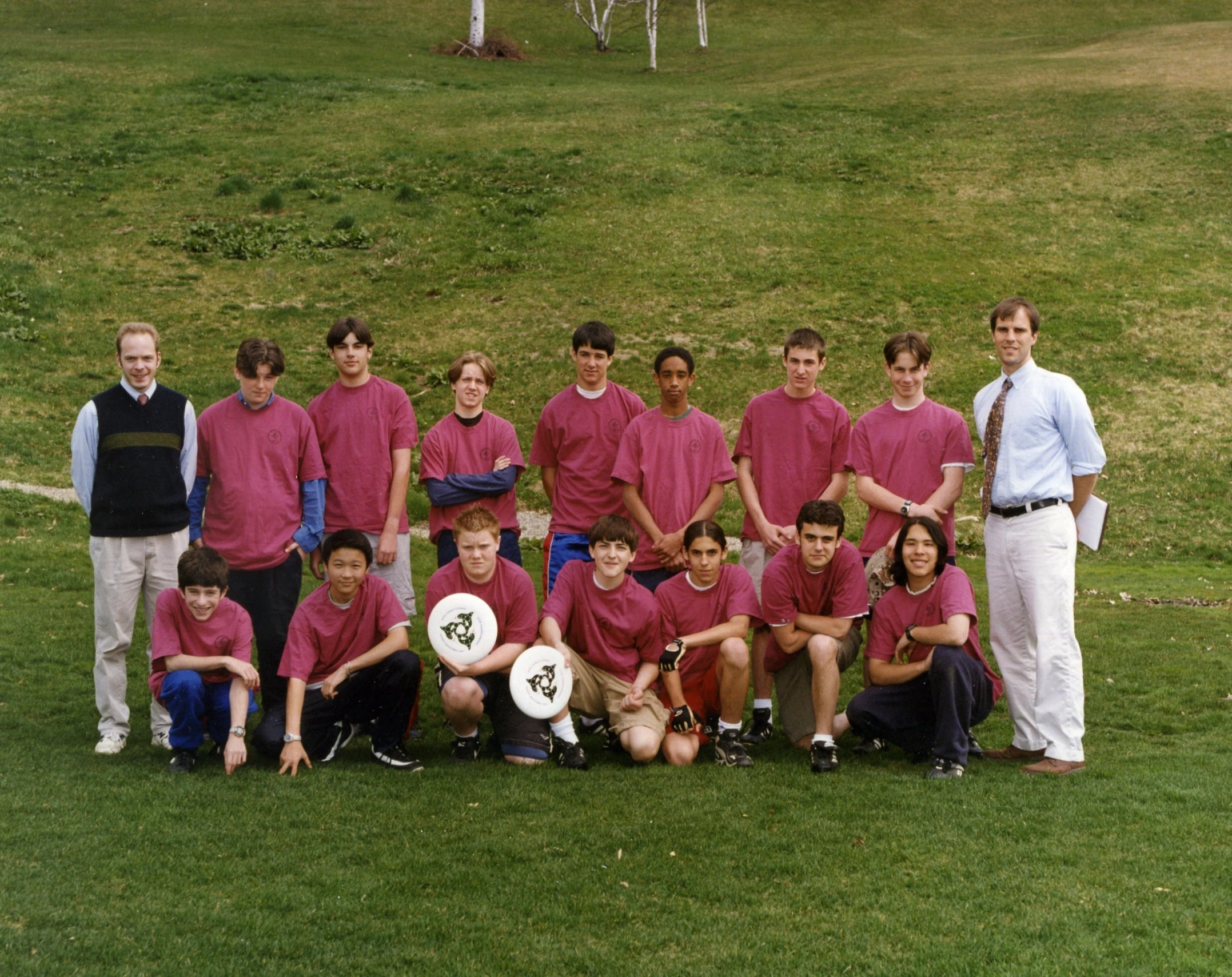 the people are posing for a team pograph on a field