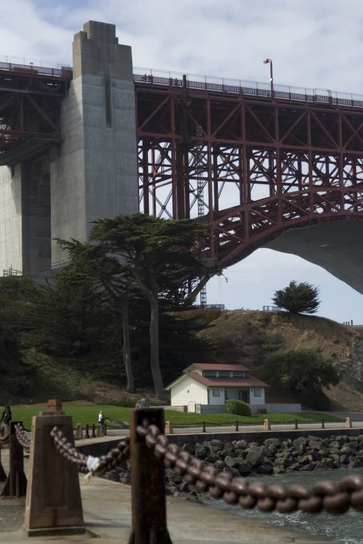 a bridge with two towers next to some trees