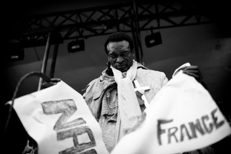 a man standing outside holding bags with france on it