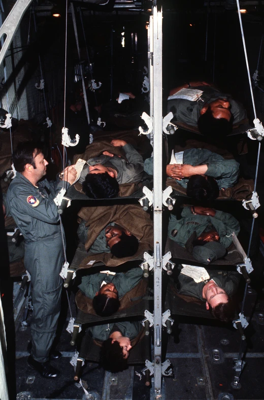 men in uniform are standing over the man lying down