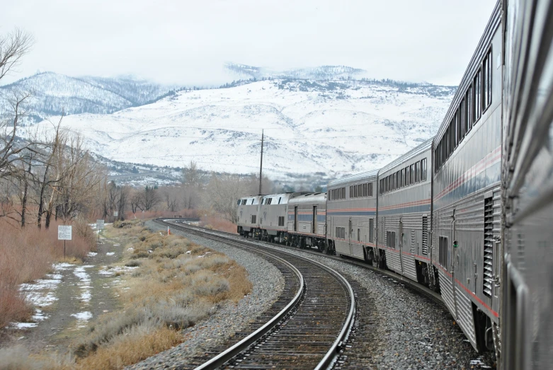 two trains are traveling down the train tracks