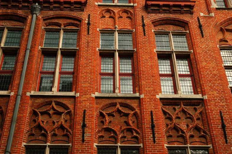 an old red brick building with decorative windows