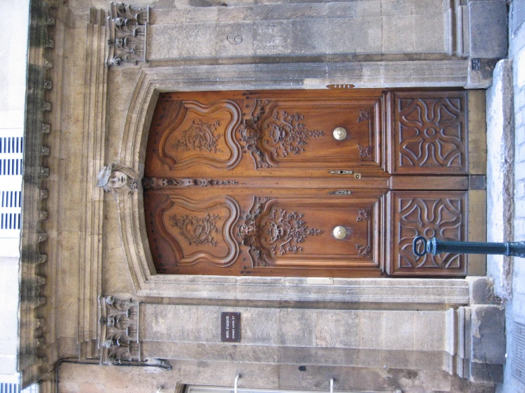 a close up of two brown doors with a fence