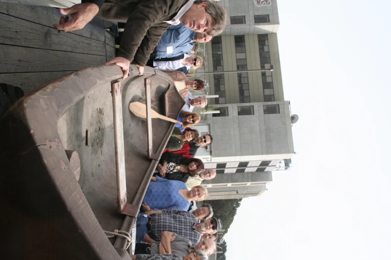 a group of people standing near a boat on the dock