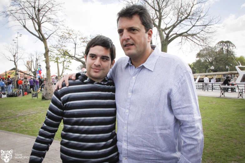 two men standing together posing for the camera