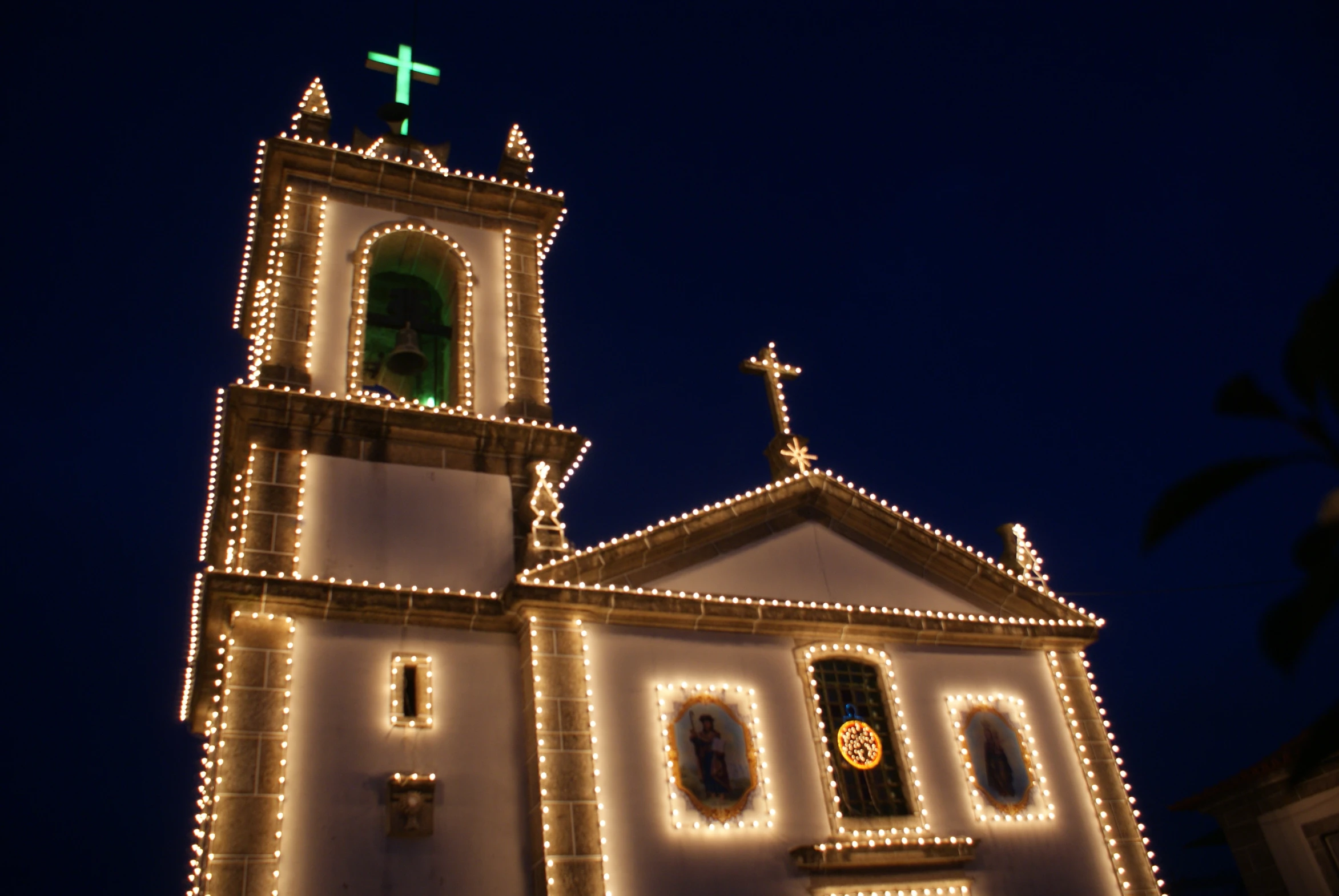 a church tower lit up with christmas lights