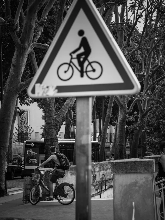 a sign warns people of bicycles being used on sidewalks