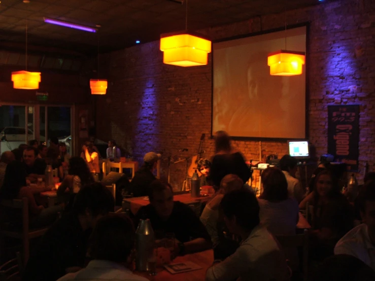 a band playing in front of people in the dark