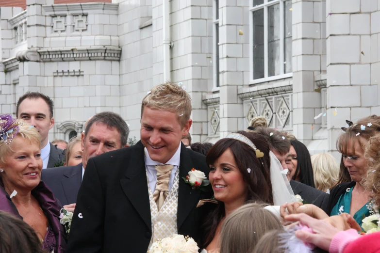 a married couple standing in front of the wedding party