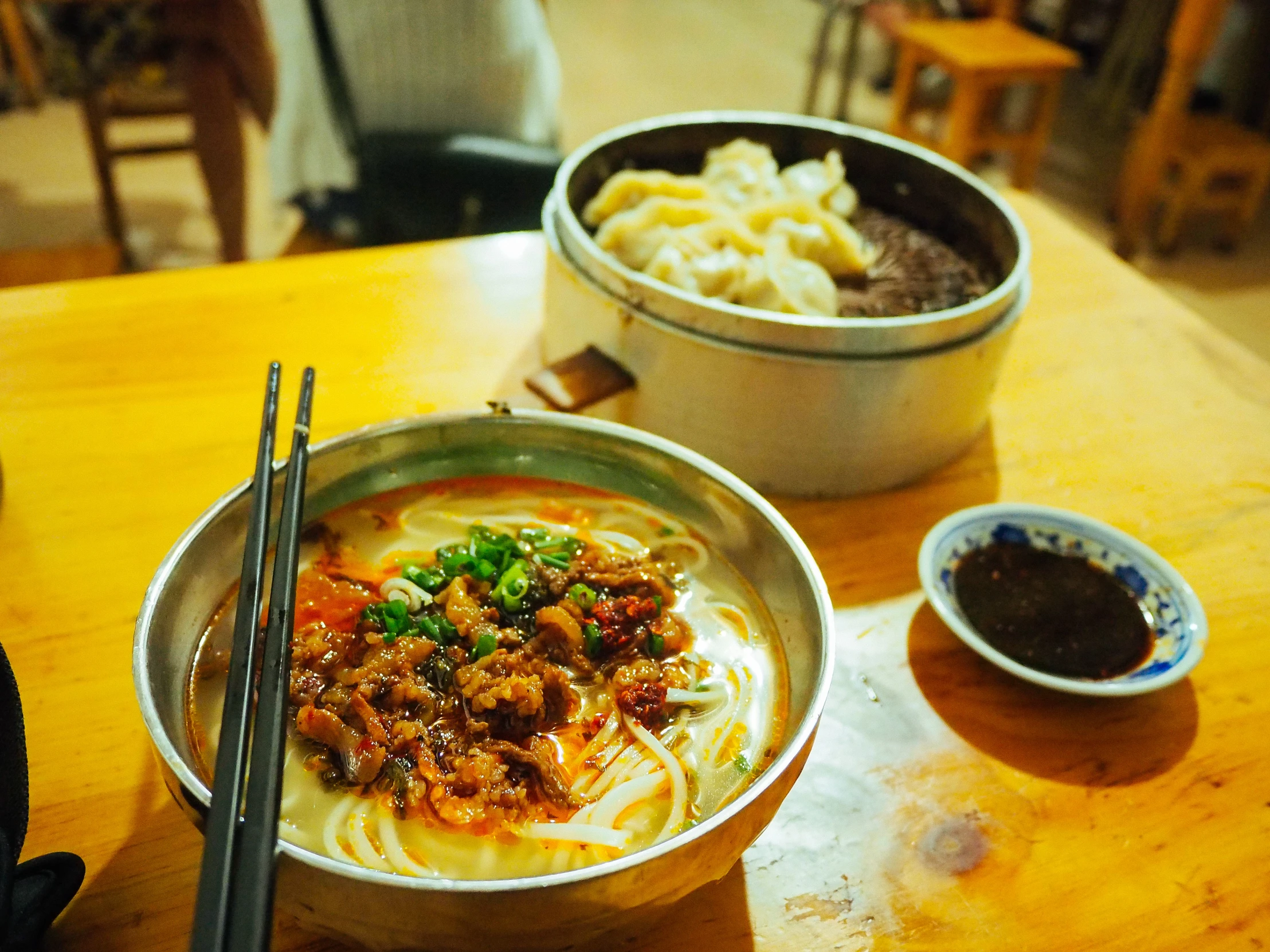 two bowls and plates of food on a table