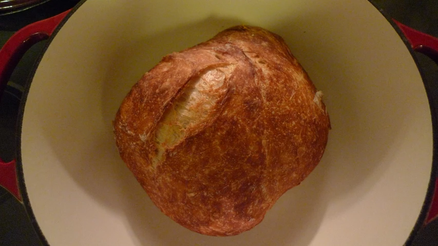 close up of a plate with a bread in it