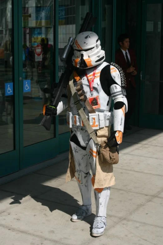 a man in a star wars outfit walking down a sidewalk